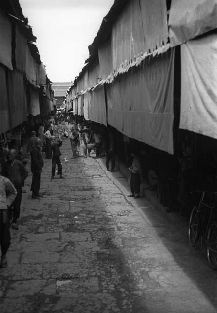 Street scene with long shades hanging over building facades