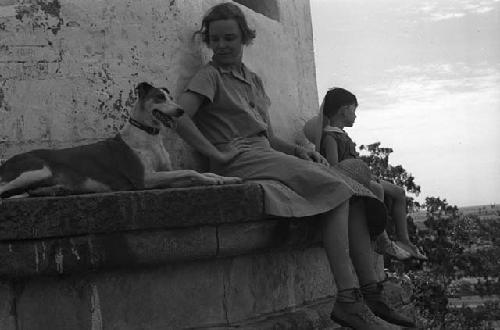 Eleanor and David Lattimore and dog on ledge of building