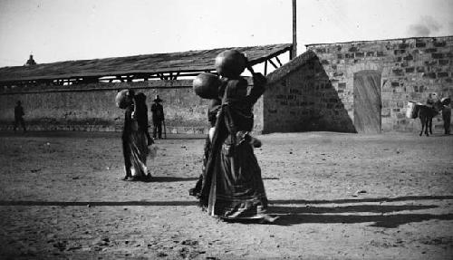 Women carrying pots on their heads