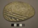 Black on white pottery reused sherd