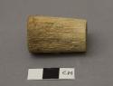 Wooden implement, cylindrical, possibly a stopper.