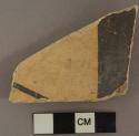 Reused black-on-yellow potsherd