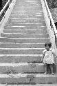 Girl holding onto hand rail on steps