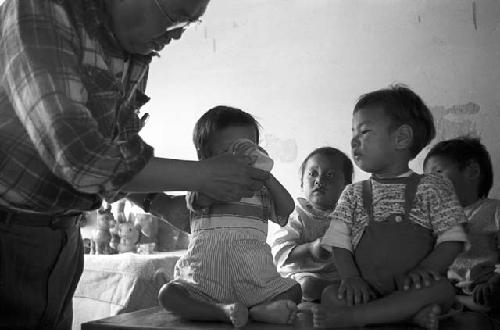 Portrait of man feeding baby milk