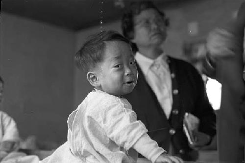 Portrait of baby boy in white garment