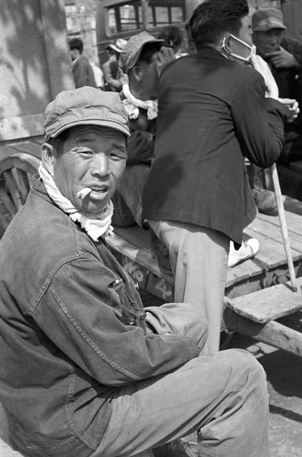 Portrait of man sitting down smoking cigar