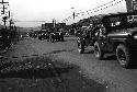 Multiple jeeps riding down the street