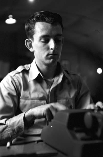 Portrait of soldier using typewriter