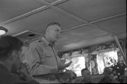 Soldier speaking at head table in front of audience