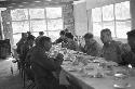 Portrait of men at large dinner table conversating before meal