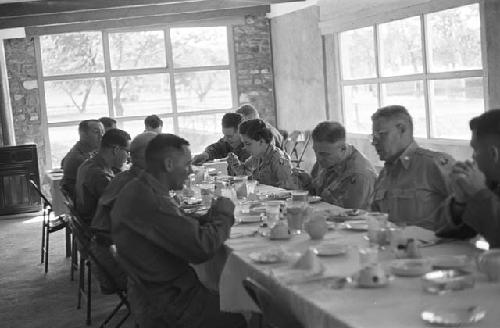 Portrait of men at large dinner table conversating before meal