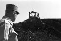 Portrait of tractor making way up dirt pile