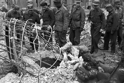 Soldiers gathered around looking at wreck