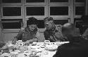 Discussion between man and woman at dinner table