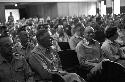 Portrait of men sitting in auditorium