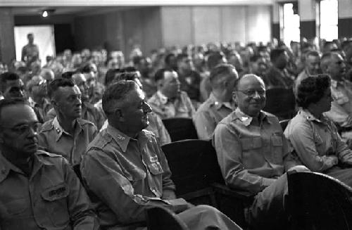 Portrait of men sitting in auditorium