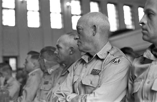 Soldiers in audience looking ahead listening