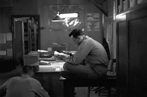 Soldiers working in office going over papers