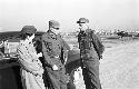 Soldiers speaking with each other on air base