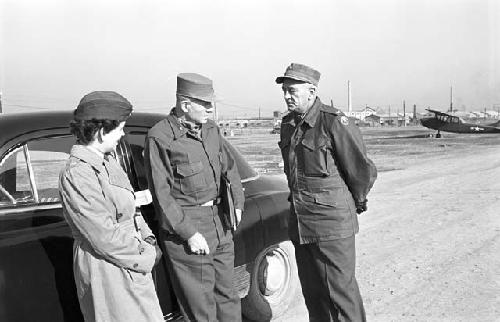Soldiers speaking with each other on air base