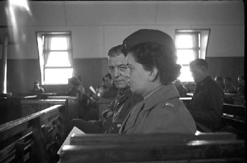 Portrait of man and woman soldier sitting together during service