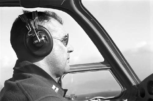 Portrait of pilot operating plane during flight