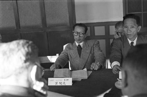 Portrait of man in suit leaning back in chair waiting for response