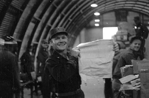 Portrait of soldier holding up garment