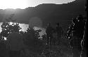 Soldiers walking down hill, Sunset in background