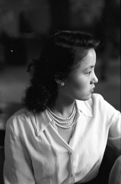 Woman posing with jewelry exposed side view