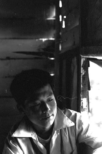 Portrait of boy sitting by window