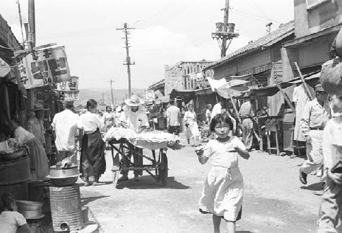 Civilians walking down a main road