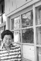 Portrait of woman wearing striped shirt outside shop