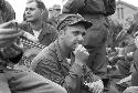 Soldiers sitting down bunched together