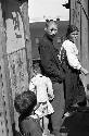 Family in alley, train passing in background