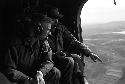 Soldiers in air craft looking down at country