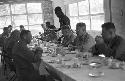 Portrait of men at large dinner table conversating before meal