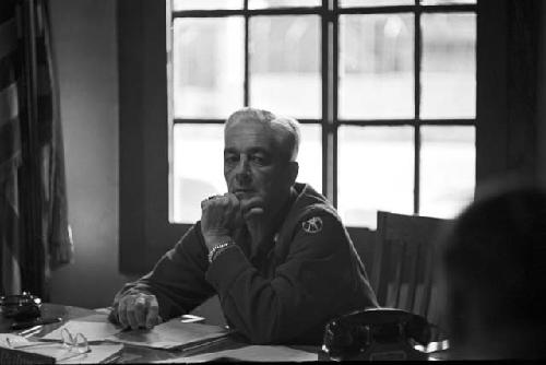 Man sitting at desk in front of window