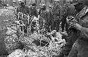 Soldiers gathered around looking at wreck