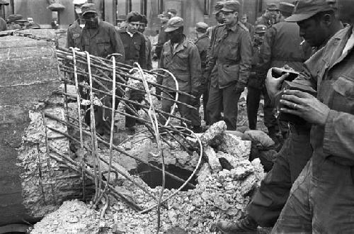 Soldiers gathered around looking at wreck