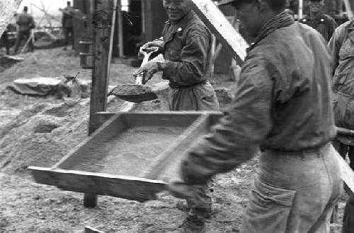 Workers hauling dirt
