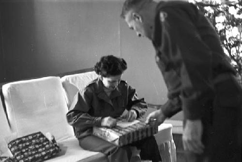 Portrait of soldier handing gift to woman