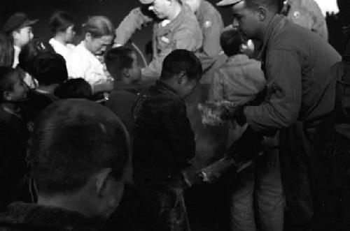 Children in the crowd recieving aid