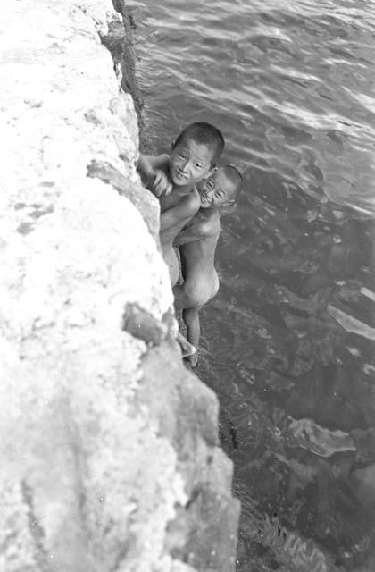 Boys Playing with each other near the water