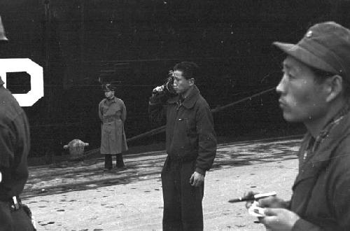 Workers standing on platform by boat