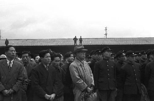 Portrait of officers and civilians lined up looking ahead