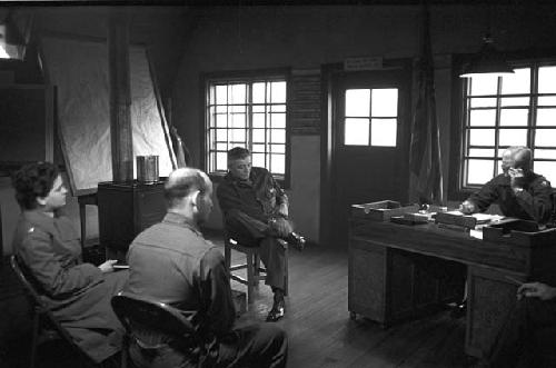 Soldiers inside office during meeting