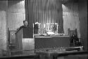 Paostor/Priest preaching at podium 2