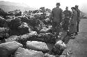 Soldiers standing around bags of luggage