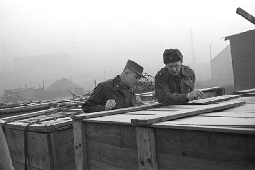 Soldiers standing together looking into boxes